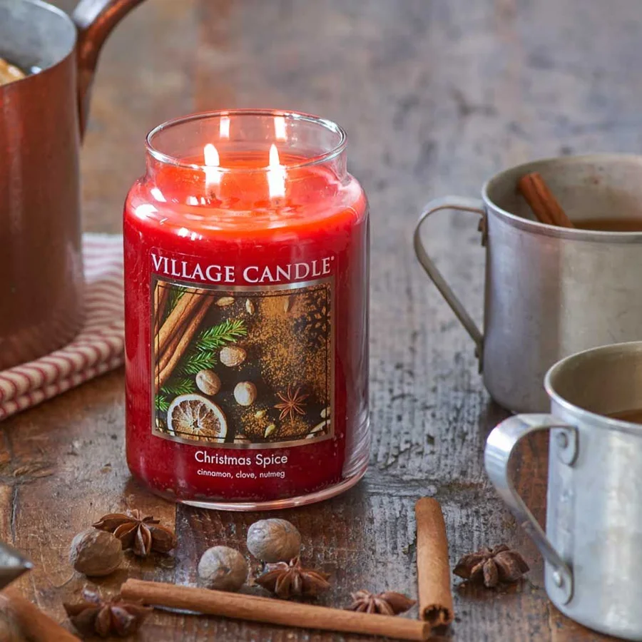 Christmas Spice two-wick jar burning beside tin mugs, star anise and cinnamon